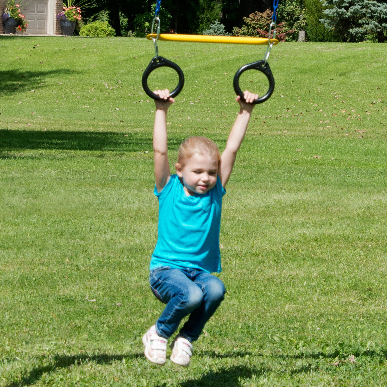 Girl holding onto trapeze rings