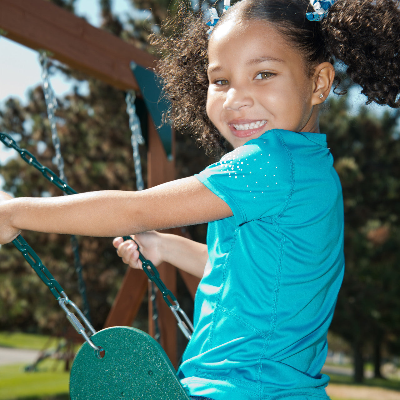 Girl enjoying Gorilla Playsets' deluxe swing belt