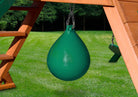 Lifestyle shot of green punching ball hanging underneath swing set.