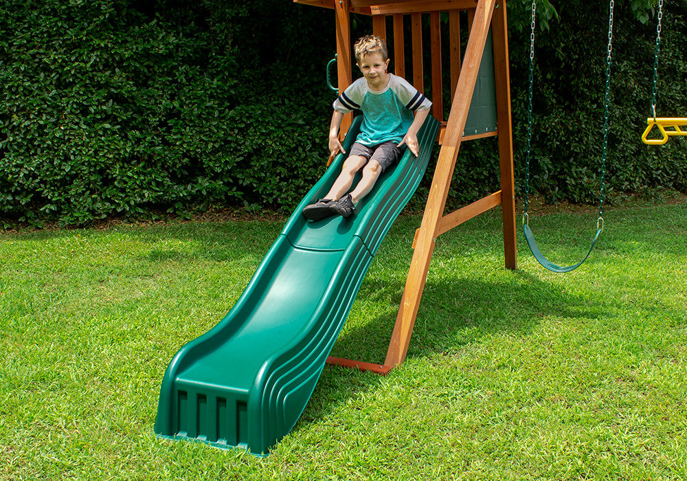 Lifestyle view of kid getting ready to slide down the 2-Piece Cool Wave Slide from PlayNation Play Systems.